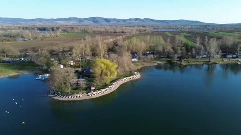 Drone half-orbit around island over lake, rising aerial shot Video stock 331820083