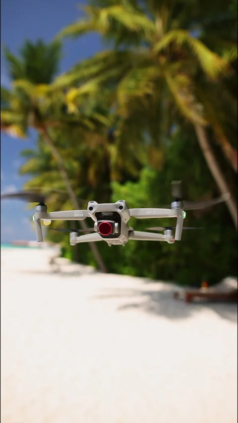 A drone hangs in the air above a beach in the Maldives. Vertical footage Stock-Footage 260340473