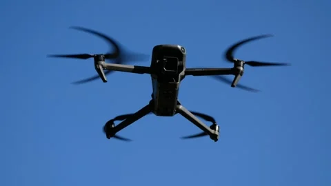 A drone hangs in a blue sky. Stock Footage 312918391