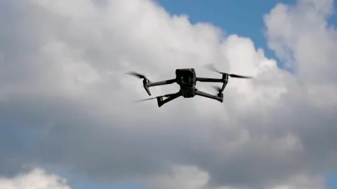 The drone hangs in the sky at a height, against the background of clouds Stock Footage 263899835