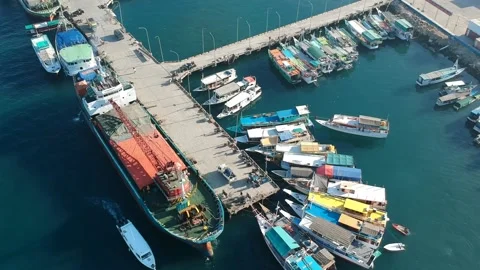 Drone, harbour, large cargo ship and small fishing boats, Indonesia Stock Footage 131435104