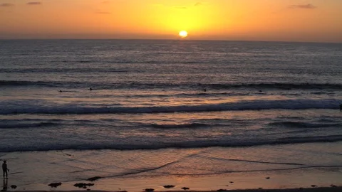 Drone HD Slow Motion - Sunset Pan Right During Golden Hour on Ocean Beach Stock Footage 128935965