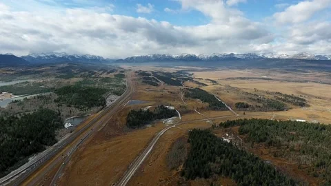 Drone high angle panorama landscape of field, pine forest and mountains, Alberta Video stock 197005761