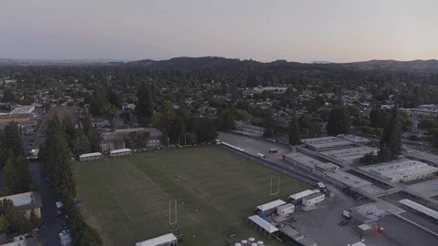Drone high angle shot of american football field with people playing match Stock Footage 120304065