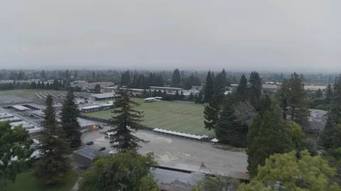 Drone high angle shot of american football field surrounded by trees Stock Footage 120304135