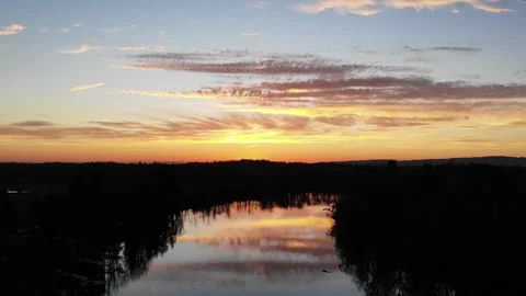Drone High Angle Sunset Reflected in River Vídeos de archivo 328382810