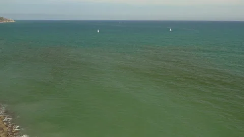 Drone high angle tracking shot from beach and over sailing boats 스톡 동영상 150405892