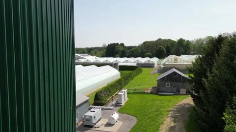 Drone - High Around Water Tower Reveiling Greenhouses Stock Footage 314228098