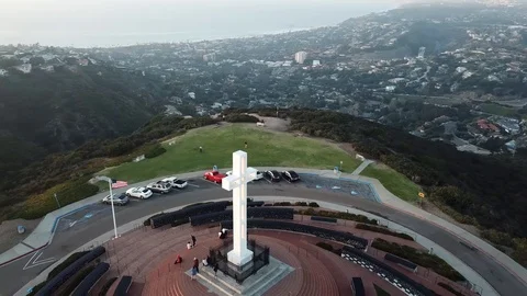 Drone high overhead circling Soledad Memorial Cross with a few tourists Stock Footage 85684232