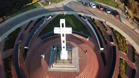 Drone high overhead circling Soledad Memorial Cross with a few tourists Stock Footage 86097780