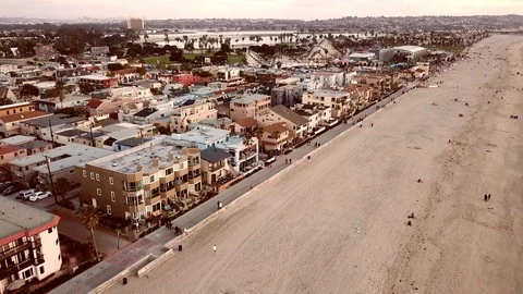 Drone high overhead flying down beach showing Mission Beach boardwalk Stock Footage 86097908