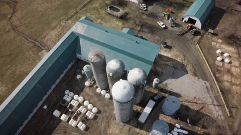 Drone high pullback tilt up view quebec dairy farm spring Stock Footage 93363023