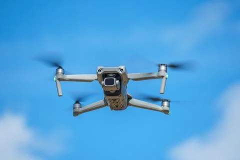 Drone with a high-resolution digital camera on a blue sky background Photos