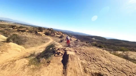 Drone high speed chase downhill mtb biker off ramps doing tricks Stock Footage 150586854