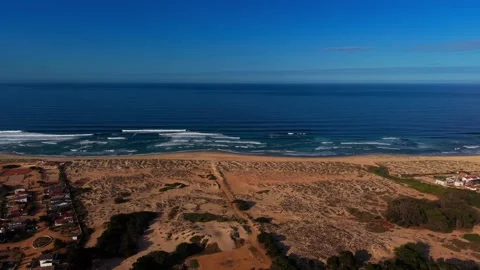 Drone Horizontal Backward Pan of Vast Coastal Sand Dunes and Residential Ho.. Video stock 339252667