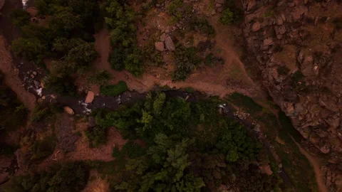 Drone Horizontal Backward Zooming Out Top Down view of a River Flowing insi.. Video stock 339254151