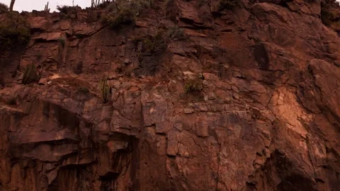 Drone Horizontal Forward Shot Climbing up a Massive Rugged Rock Cliff Face .. Video stock 339254170