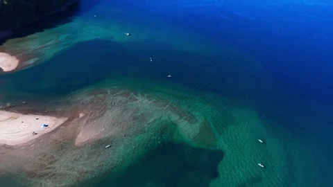 Drone Horizontal Forward Tilting Up View from Beach Pier to a Large Blue La.. Stock Footage 339252279