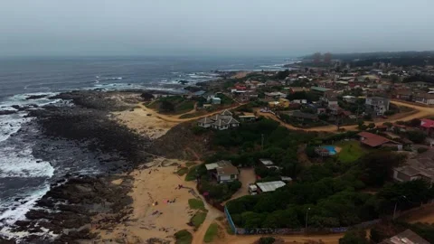 Drone Horizontal Forward View of a Coastal Village and Rocky Coastline Unde.. Video stock 339253300