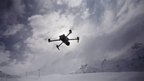Drone Hovering Above Snowy Mountain Landscape Beneath Dramatic Clouds Stock Footage 339069909