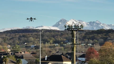 Drone hovering above village rooftops with electricity infrastructure and Stock Footage 337958835