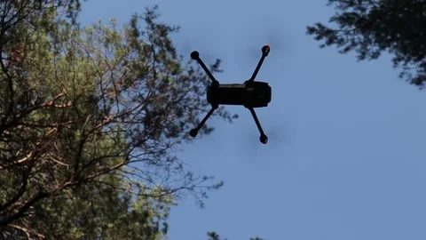 Drone hovering in the air with forest background Vídeos de archivo 134338131
