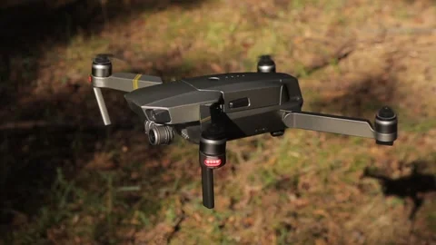 Drone hovering in the air with forest background Stock Footage 134338133