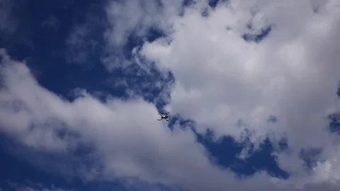 Drone hovering and coming in for a landing with clouds in the background Stock Footage 142336125
