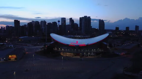 Drone hovering around Calgary Saddledome at dusk after the sunset Stock Footage 219996887