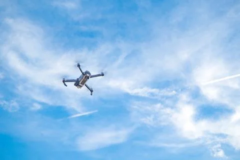 Drone hovering in blue sky Stock Photos