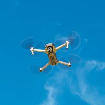 Drone hovering in the blue sky Stock Photos