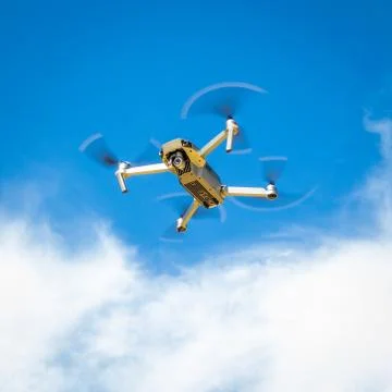 Drone hovering in the blue sky Stock Photos