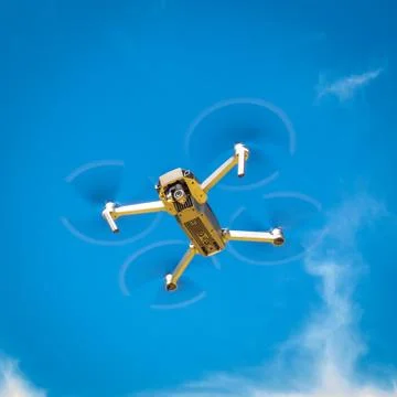 Drone hovering in the blue sky Stock Photos