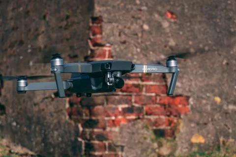 Drone hovering in front of brick wall Stock Photos
