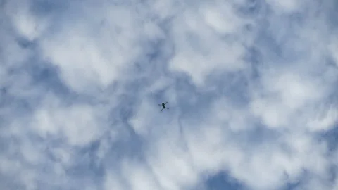 Drone hovering high among drifting clouds in soft daylight Stock Footage 330184428
