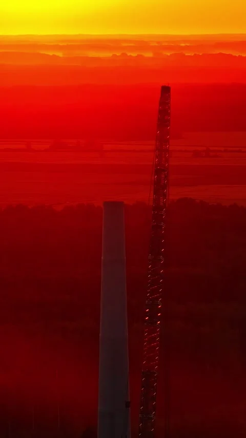 Drone Hovering Near a Large industrial crane during a brilliant sunset Stock Footage 336801649