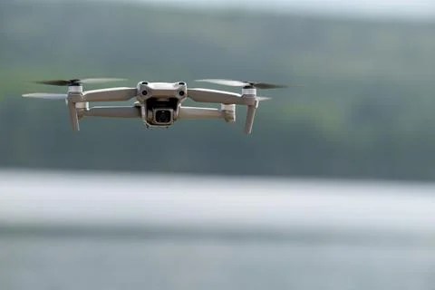 Drone hovering over a lake with a blurred background Stock Photos