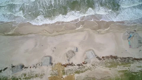 Drone hovering over old World War 2 bunkers at the Danish West coast Stock Footage 335996497