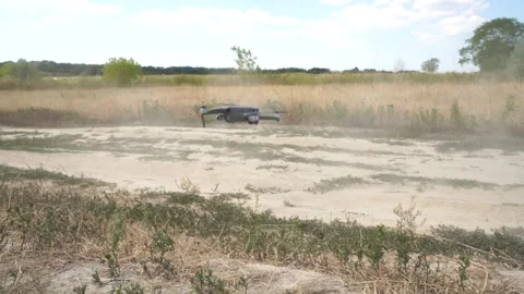 Drone with hovering over a sandy field Stock Footage 242340212