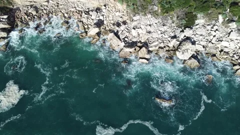 Drone hovering over the seashore without moving. Stones, waves, coast Stock Footage 237015013