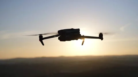 A drone hovering in the path of sunset Stock Footage 240397975