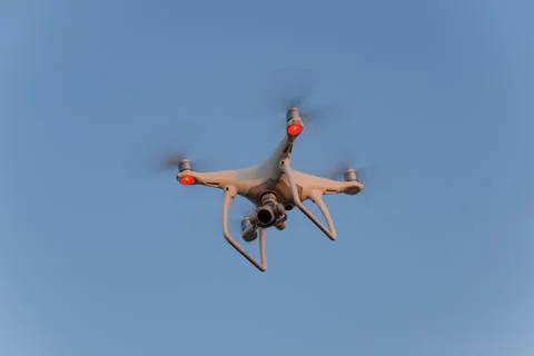 The drone, hovering in the sky. Flight quadrocopters Stock Photos