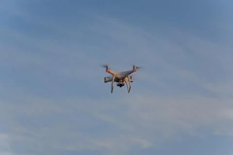 The drone, hovering in the sky. Flight quadrocopters Stock Photos