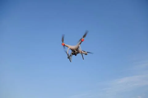 The drone, hovering in the sky. Flight quadrocopters Stock Photos