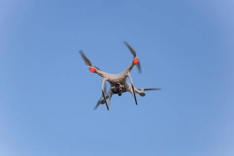 The drone, hovering in the sky. Flight quadrocopters Stock Photos