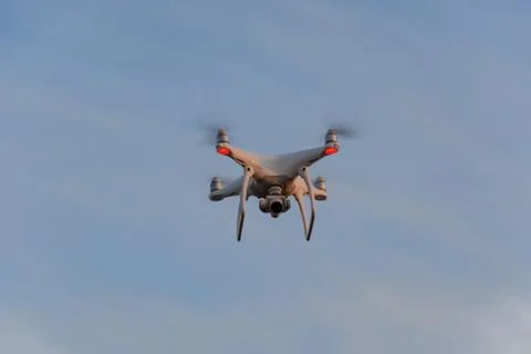 The drone, hovering in the sky. Flight quadrocopters Stock Photos