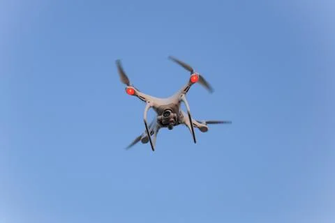 The drone, hovering in the sky. Flight quadrocopters Stock Photos