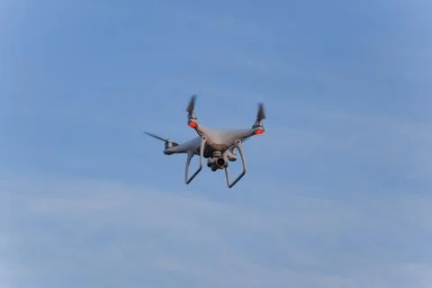 The drone, hovering in the sky. Flight quadrocopters Stock Photos