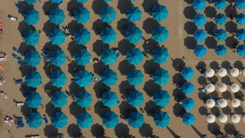Drone Hovering Still Above Symmetrically Positioned Blue Beach Umbrellas Stock Footage 111344485