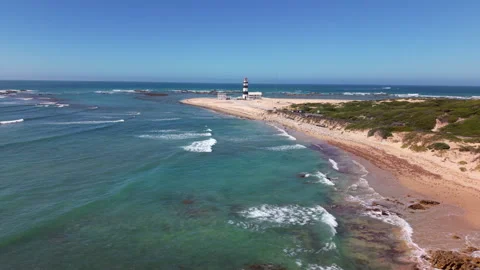 Drone Hovering with View of Distant Lighthouse, Sea, Waves, Coastline, Coastal R Stock Footage 306355064